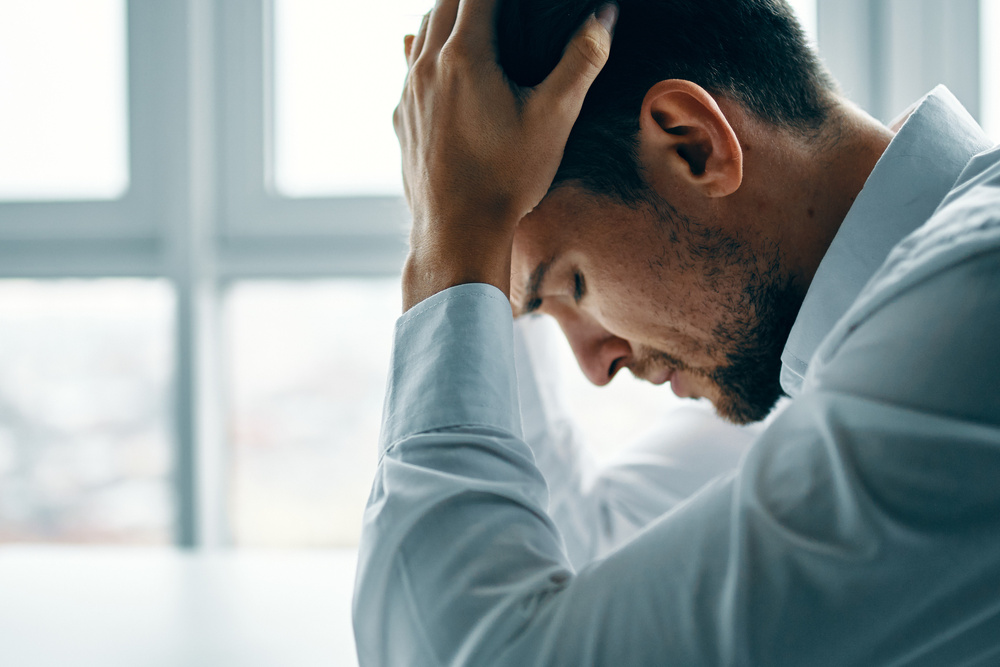 Stressed Man near Window