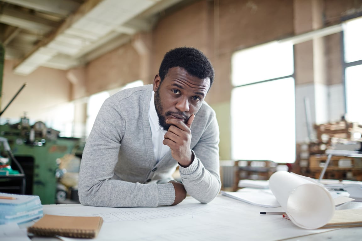 Introspective engineer thinking of factory machine development